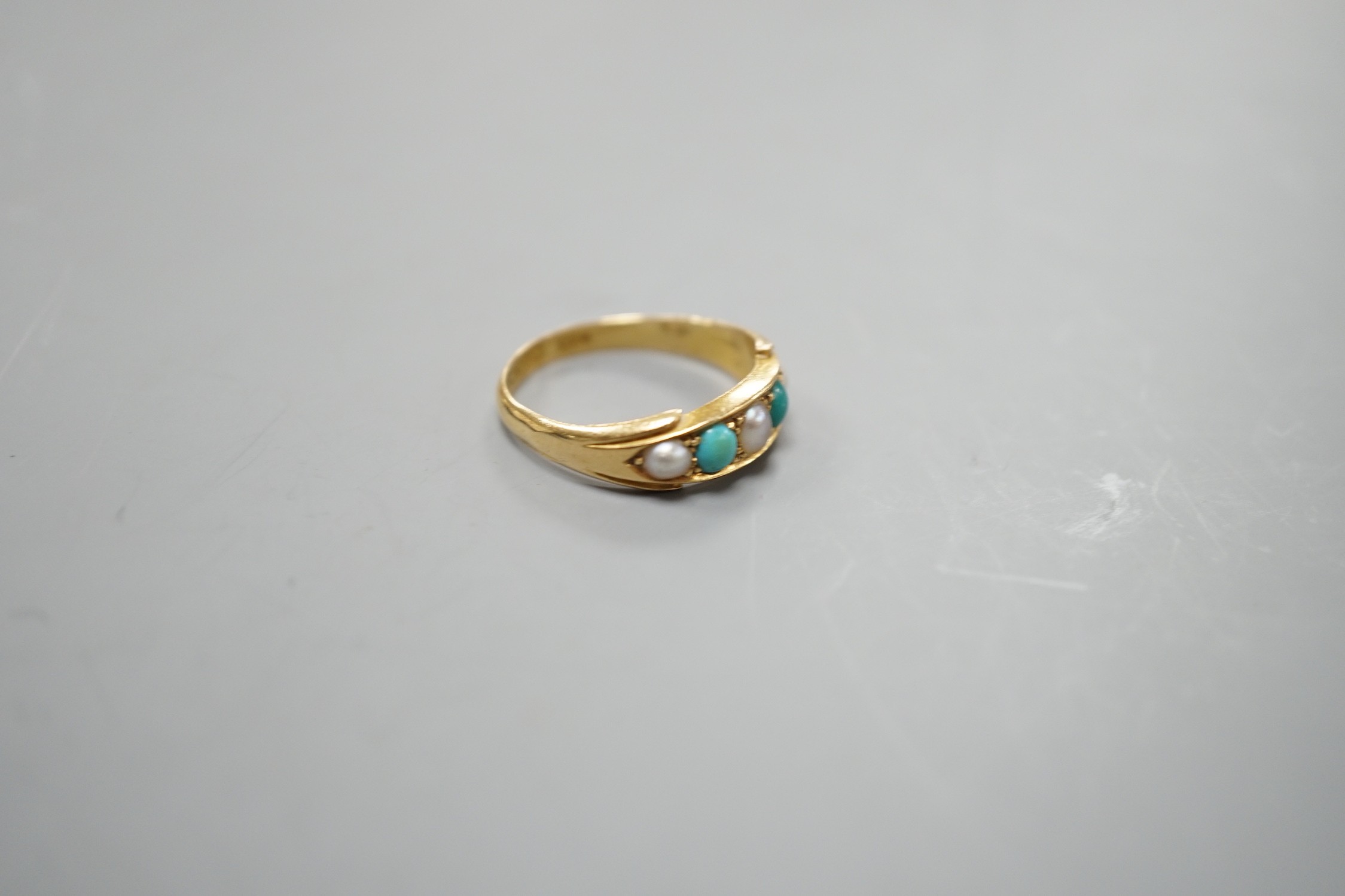 A late Victorian 18ct gold, graduated split pearl and turquoise set five stone half hoop ring, size P/Q, gross weight 4.2 grams.